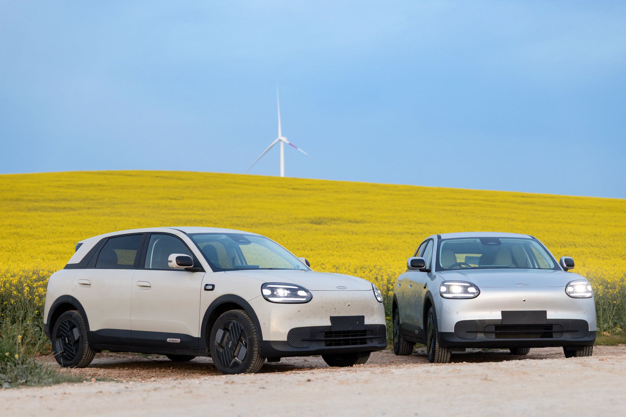 Two Chery Q vehicles in a yellow field